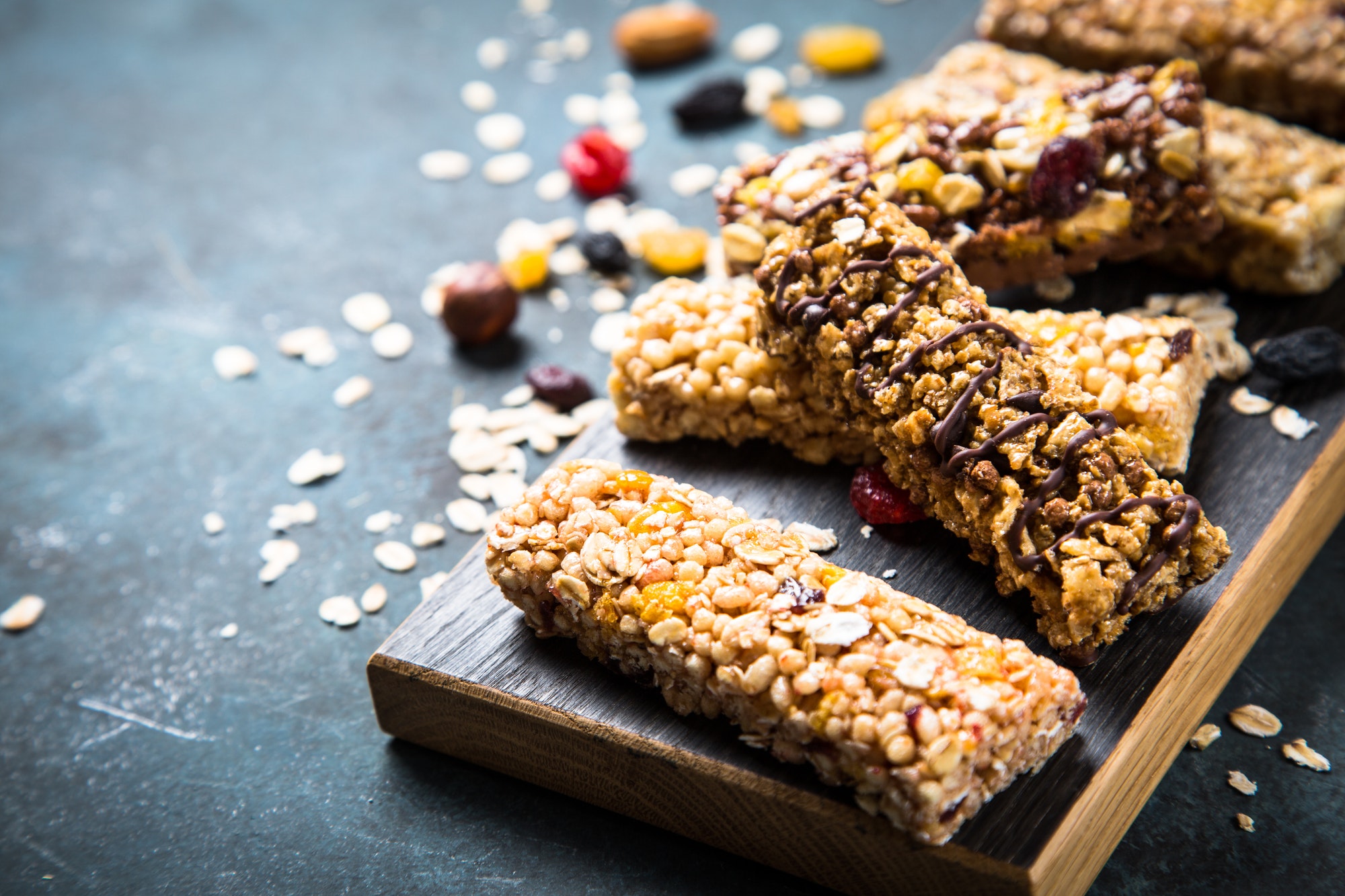 Granola bar with nuts, fruit and berries on black
